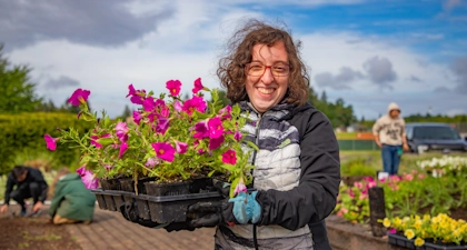 Person holding a box of flowers