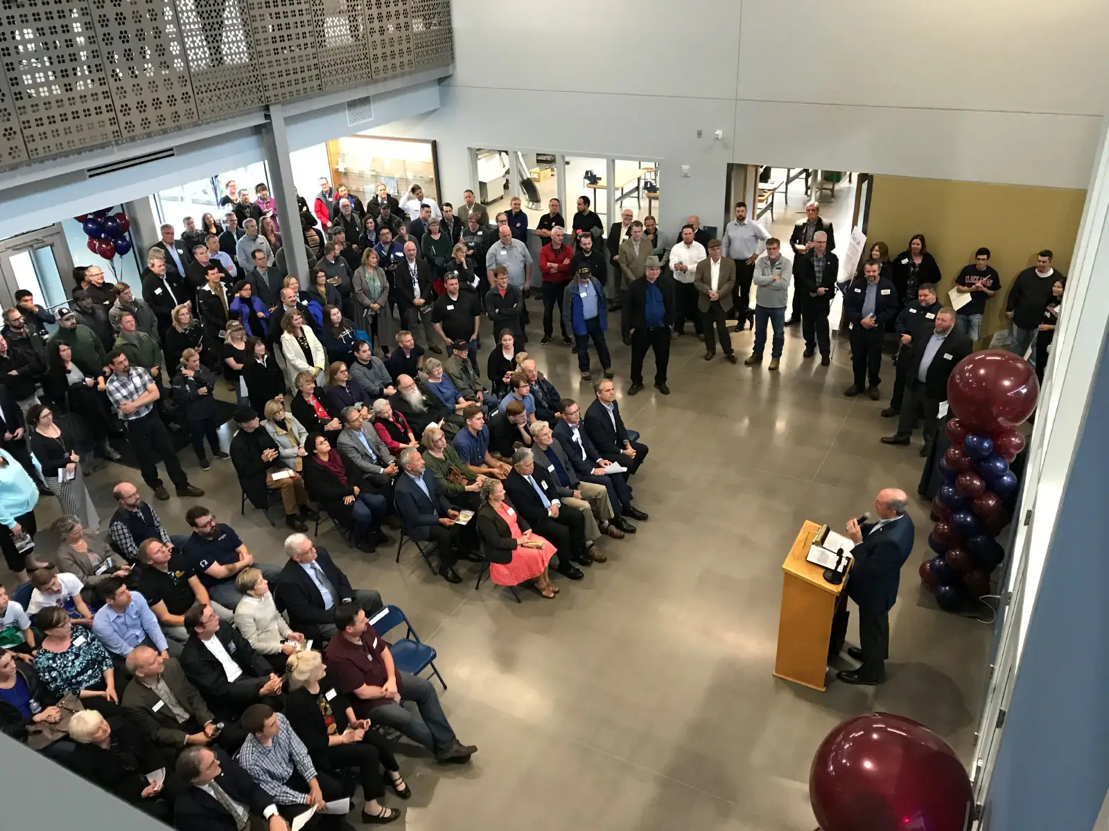 The grand opening of the Industrial Technology Center with a large audience and speakers