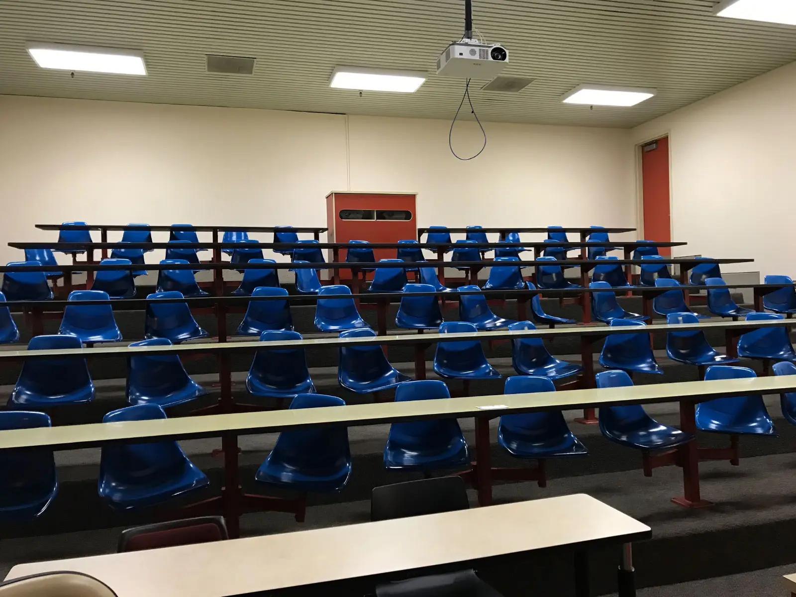 The Pauling Lecture Hall with dozens of blue, swiveling seats, located at the Oregon City campus