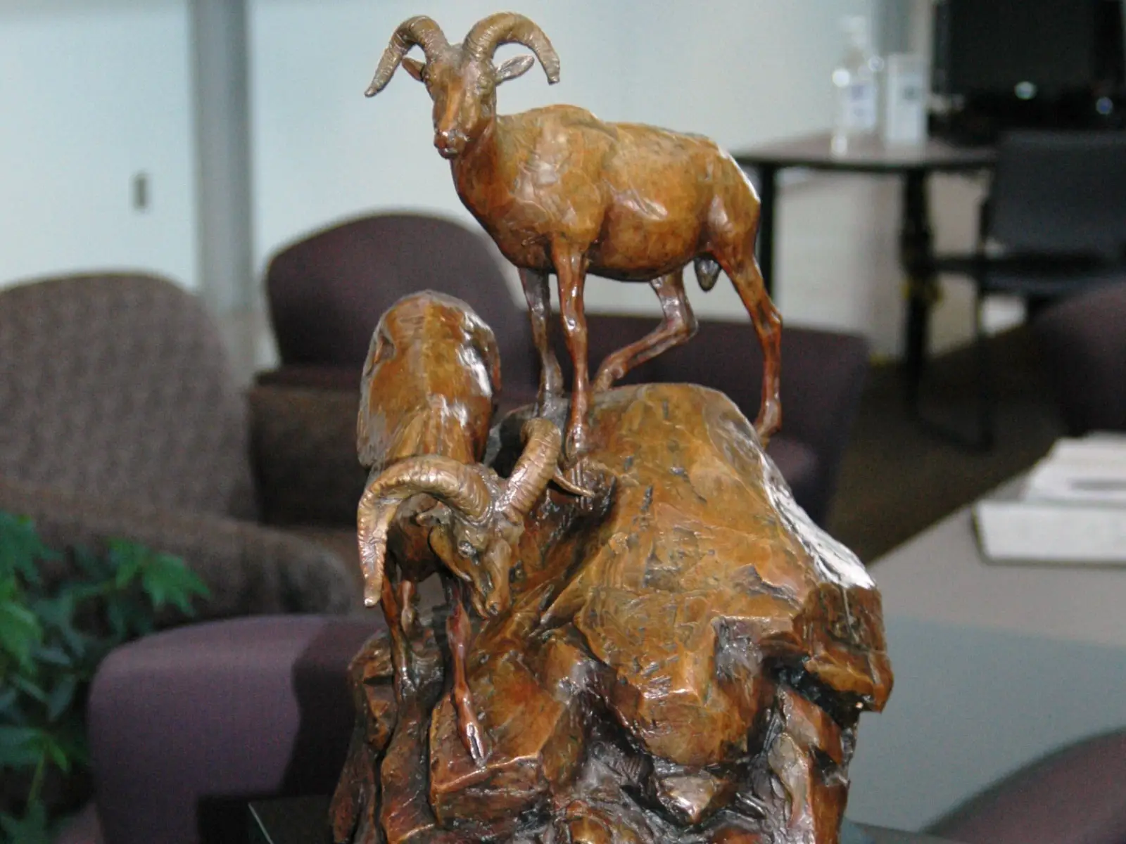 Statue art piece of two goats on a mountain in the Wilsonville campus' commons gallery