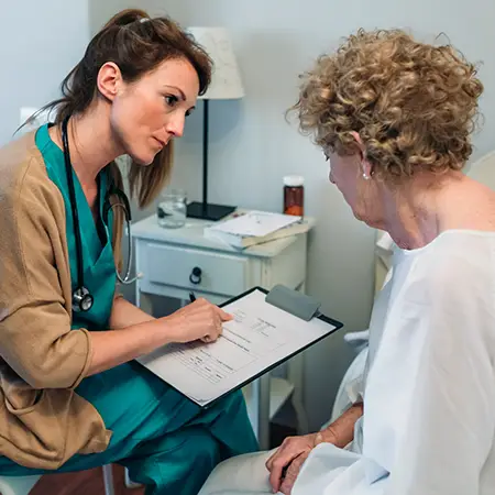 A health care professional reviews test results with an older adult patient.