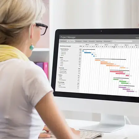 Woman uses project management software to chart the tasks and timelines of a project.