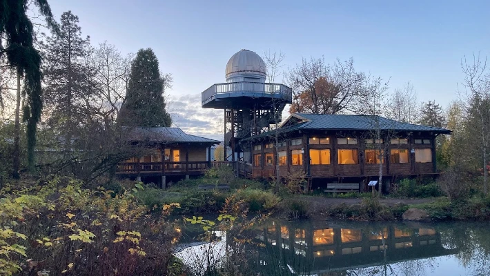 View of CCC's Environmental Learning Center and Haggart Observatory from across the water